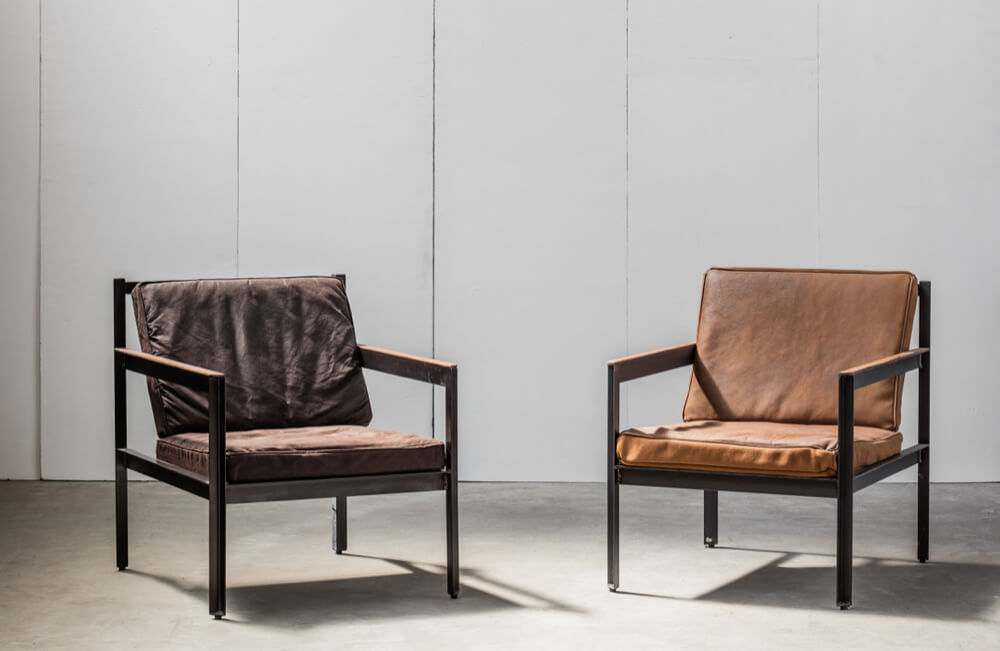 Cargo armchair with waxed canvas cushions (L) or distressed leather cushions (R) by Heerenhuis